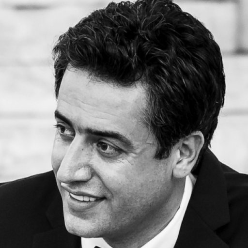 Middle aged man looking to the left, clean cut with black hair