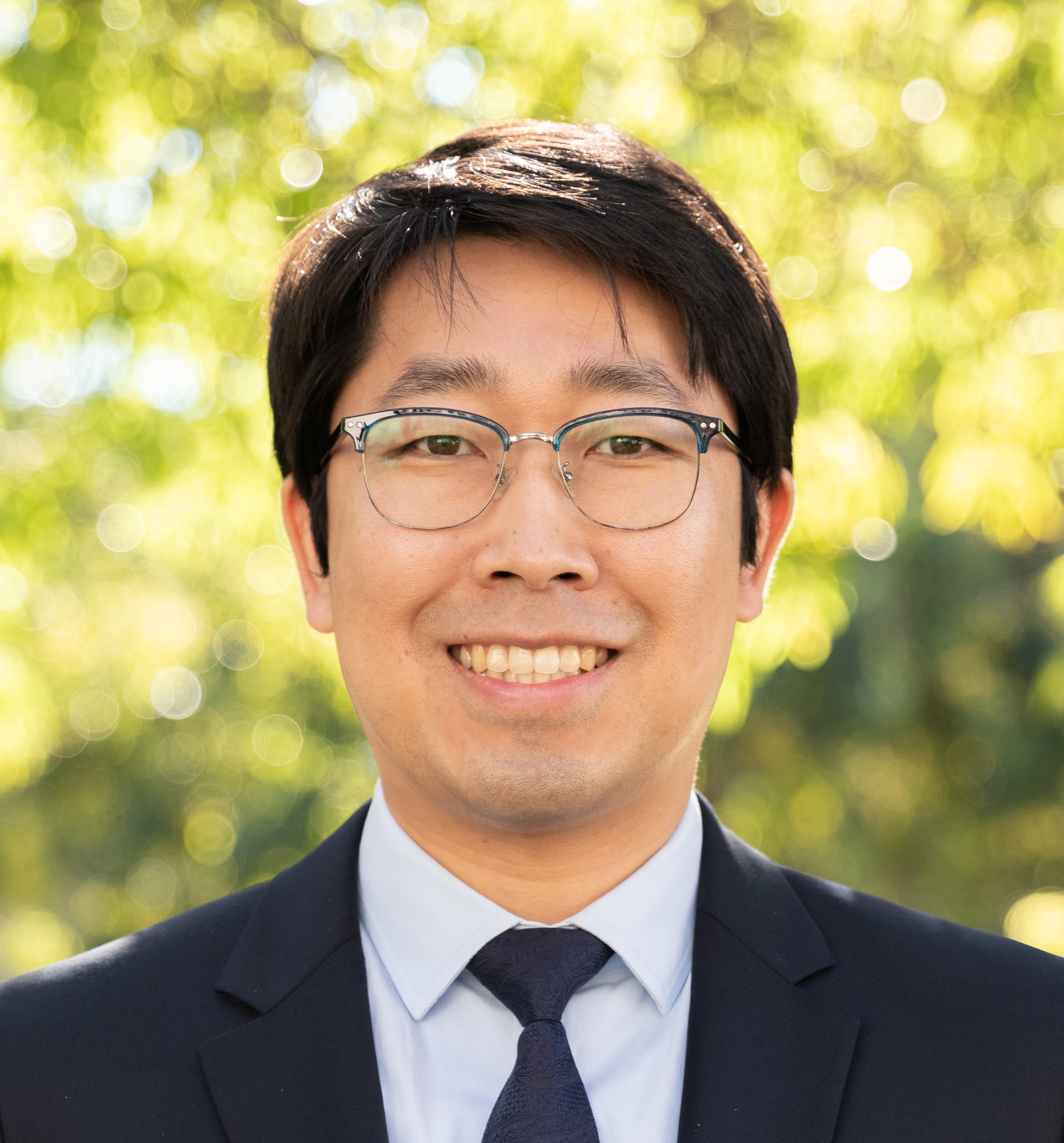 image of Hyoyoung in suit and glasses