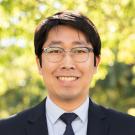 image of Hyoyoung in suit and glasses
